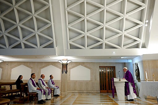 Pope Francis celebrates Mass at his Santa Marta residence at the Vatican, Friday, March 20, 2020.  The Vatican says the Catholic church is granting a special lifting of punishment and forgiveness for sins for all those faithful infected with the coronavirus as well as health personnel, family members or others caring for those sick. The Holy See on Friday issued a decree that grants plenary indulgences. For most people, the new coronavirus causes only mild or moderate symptoms. For some it can cause more severe illness. (Vatican News via AP)