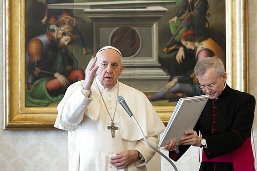 Pope Francis delivers his blessing during his weekly general audience at the Vatican, Wednesday, March 18, 2020. For most people, the new coronavirus causes only mild or moderate symptoms. For some it can cause more severe illness, especially in older adults and people with existing health problems. (Vatican News via AP)