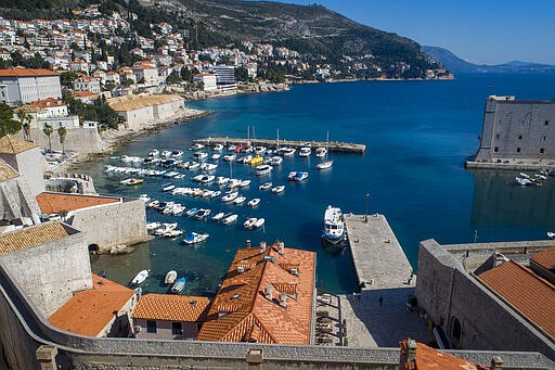 This Tuesday, March 17, 2020 aerial photo shows the old town harbor and the Lazarettos, called Lazareti in Croatian, of Dubrovnik, in Dubrovnik, Croatia. Just outside the majestic walls of Croatia&#146;s medieval citadel city of Dubrovnik lies a cluster of small stone houses known as the Lazzarettos of Dubrovnik, today an art and clubbing hub and a tourist attraction. But the coronavirus spreads worldwide, some are recalling their original purpose centuries ago as an isolation zone for arrivals who might be carrying infectious diseases. Dubrovnik, on the Adriatic coast, was the first city in Europe to set up a quarantine system, in 1377, as protection from leprosy. The Lazzarettos complex was built in the 17th century when authorities decided to set up the quarantine area closer to the harbor.   (AP Photo/Darko Bandic)