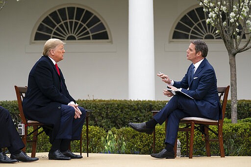 President Donald Trump talks with host Bill Hemmer during a Fox News virtual town hall with members of the coronavirus task force, in the Rose Garden at the White House, Tuesday, March 24, 2020, in Washington. (AP Photo/Evan Vucci)