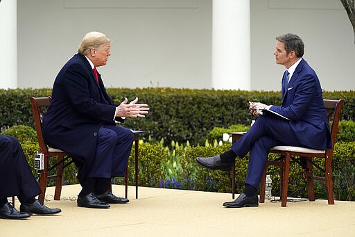 President Donald Trump speaks with Fox News Channel Anchor Bill Hemmer during a Fox News Channel virtual town hall, at the White House, Tuesday, March 24, 2020, in Washington. (AP Photo/Evan Vucci)