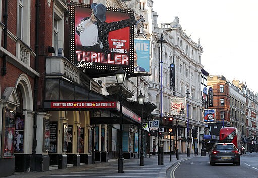 Streets are mostly empty and Theatres are closed in the normally busy theatreland area of central London, Tuesday, March 24, 2020.  Britain's Prime Minister Boris Johnson on Monday imposed its most draconian peacetime restrictions on businesses and public gatherings due to the spread of the coronavirus. The highly contagious COVID-19 coronavirus can cause mild symptoms, but for some it can cause severe illness including pneumonia..(AP Photo/Frank Augstein)