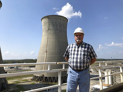 Steve Holland, general manager of the Paradise Fossil Plant, stands near one of the plant's cooling towers in Drakesboro, Ky., on Sept. 12, 2019. Holland oversaw the Tennessee Valley Authority plant as it burned its last load of coal and shut down in February. (AP Photo/Dylan Lovan)