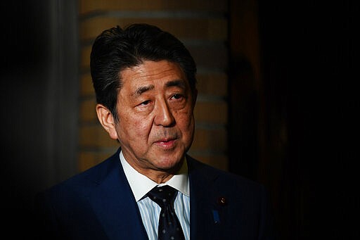 Japan's Prime Minister Shinzo Abe talks to journalists in front of the prime minister's residence in Tokyo, Tuesday, March 24, 2020. Abe says IOC president has agreed &quot;100%&quot; to proposal of postponing Olympics for about 1 year. (Charly Triballeau/Pool Photo via AP)