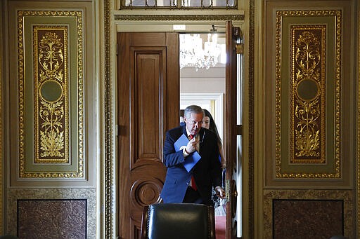 Acting White House chief of staff Mark Meadows departs a meeting on Capitol Hill in Washington, Tuesday, March 24, 2020, as the Senate works to pass a coronavirus relief bill. (AP Photo/Patrick Semansky)