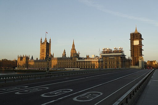 An almost empty Westminster Bridge normally a very busy river crossing as the sun rises in London, Tuesday, March 24, 2020. Britain's Prime Minister Boris Johnson on Monday imposed its most draconian peacetime restrictions due to the spread of the coronavirus on businesses and gatherings, health workers begged for more gear, saying they felt like &quot;cannon fodder.&quot; For most people, the new coronavirus causes only mild or moderate symptoms, such as fever and cough. For some, especially older adults and people with existing health problems, it can cause more severe illness, including pneumonia. (AP Photo/Matt Dunham)