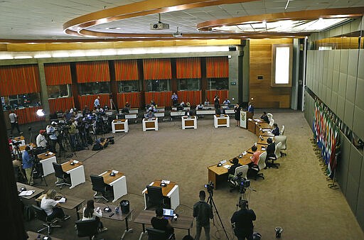 Members of the National Command Council's Economic Cluster conduct a press conference to outline in detail the government's intervention measures on the COVID-19 coronavirus, at the OR Tambo Building in Pretoria, South Africa, Tuesday March 24, 2020, one day after South African President Cyril Ramaphosa announced a three-week national lockdown to contain the spread of the coronavirus. For most people the virus causes only mild or moderate symptoms. For others it can cause more severe illness, especially in older adults and people with existing health problems. (Phill Magakoe/Pool Photo via AP)