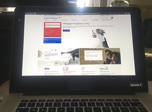 Bank of America's homepage is displayed on a computer screen in White Plains, N.Y., on Tuesday, March 24, 2020. Online banking lets you manage your finances remotely, without visiting a bank branch. That is particularly helpful as many people self-isolate to avoid contracting or spreading the coronavirus. (AP Photo)