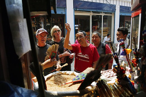 FILE - In this May 9, 2019, file photo, Apa Sherpa gestures while walking with members of his foundation in Kathmandu, Nepal. The 60-year-old mountaineer from Nepal who now lives in Salt Lake City applauded the decision to shut down the routes to the top of the famed Himalayan mountain over concerns about the new coronavirus. That meant Sherpa didn't have to worry about the health of anyone on the mountain, including his niece, nephew and cousin as they follow in his Everest-climbing footsteps. Now, he has another fear: How will those who work in the shadow of Everest make ends meet? (AP Photo/Niranjan Shrestha, File)