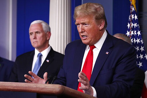 President Donald Trump speaks about the coronavirus in the James Brady Briefing Room, Tuesday, March 24, 2020, in Washington, as Vice President Mike Pence listens. (AP Photo/Alex Brandon)