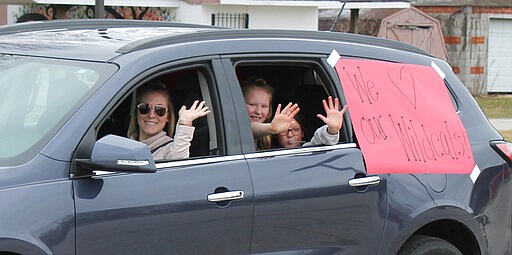 Teachers, staff and bus drivers from Coolspring Elementary School in Michigan City visited their students face-to-face &#8211; but social distancing style &#8211; with a caravan of vehicles on Monday, March 24, 2020. (Kelley Smith/The News-Dispatch via AP)