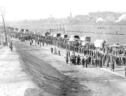 FILE - In this Dec. 5, 1932, file photo, a general view as the nearly 2,500 demonstrators, cold and cramped from a night spent in their trucks and automobiles, assembled in line for their food rations at their encampment on the outskirts of Washington. Nearly a century later, the U.S. economy is all but shut down, and layoffs are soaring at small businesses and major industries. A devastating global recession looks inevitable. Deepening the threat, a global oil price war has erupted. Some economists foresee an economic downturn to rival the Depression. (AP Photo)