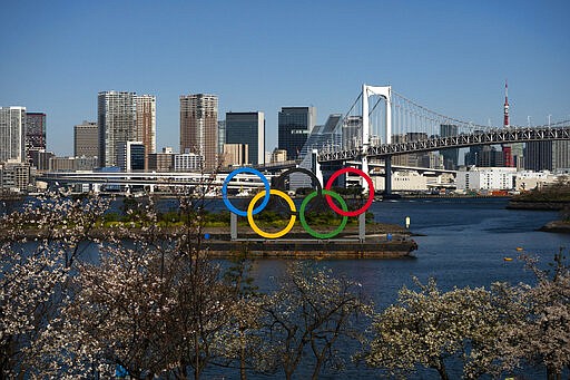 A barge carrying the Olympic rings floats in the water Wednesday, March 25, 2020, in the Odaiba section of Tokyo. Not even the Summer Olympics could withstand the force of the coronavirus. After weeks of hedging, the IOC took the unprecedented step of postponing the world's biggest sporting event, a global extravaganza that's been cemented into the calendar for more than a century. (AP Photo/Jae C. Hong)