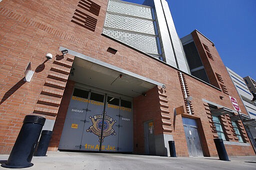 FILE - This March 21, 2020 file photo shows the Maricopa County 4th Avenue Jail in downtown Phoenix. In an effort to guard against the risks of COVID-19, Maricopa County Sheriff Paul Penzone has raised the possibility of getting courts to temporarily suspend the sentences of nonviolent misdemeanor inmates who are allowed to leave jail to go to work. Last week, Penzone said he wouldn't prematurely release inmates without court orders. (AP Photo/Ross D. Franklin, File)