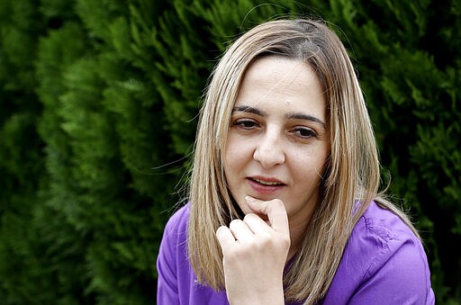 FILE - In this Feb 25, 2020, file photo Aya Al-Umari, whose brother Hussein Al-Umari was killed in the Al Noor mosque shooting, reacts during an interview at her home in Christchurch, New Zealand. One year after killing 51 worshipers at two Christchurch mosques, an Australian white supremacist accused of the slaughter has changed his plea to guilty. Twenty-nine-year-old Brenton Harrison Tarrant on Thursday, March 26, 2020, pleaded guilty to 51 counts of murder, 40 counts of attempted murder and one count of terrorism. (AP Photo/Mark Baker, File)