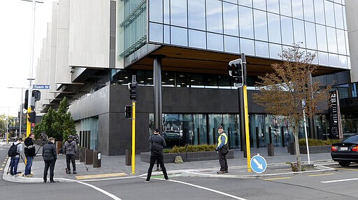 Media film outside the Christchurch High Court in Christchurch, New Zealand, Thursday, March 26, 2020. One year after killing 51 worshipers at two Christchurch mosques, an Australian white supremacist accused of the slaughter on Thursday changed his plea to guilty. Twenty-nine-year-old Brenton Harrison Tarrant pleaded guilty to 51 counts of murder, 40 counts of attempted murder and one count of terrorism. (AP Photo/Mark Baker)