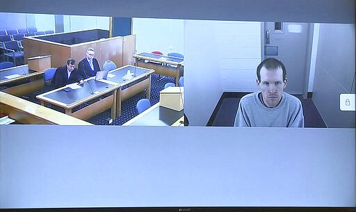 This image made from a video, shows Brenton Harrison Tarrant, right, and lawyers in a screen via video link in Christchurch, New Zealand Thursday, March 26, 2020. One year after killing 51 worshipers at two Christchurch mosques, Tarrant, an Australian white supremacist accused of the slaughter has changed his plea to guilty. (TVNZ Pool via AP)