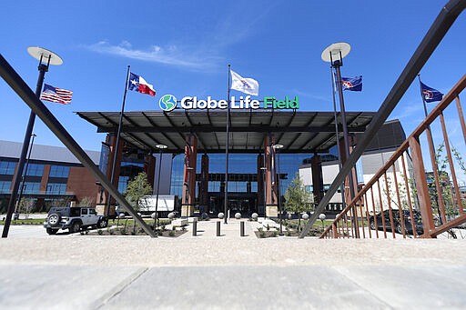 The South East entrance to the newly constructed home of the Texas Rangers baseball club, Globe Life Field, sits empty of any pedestrian traffic in Arlington, Texas, Wednesday, March 25, 2020.  Instead of MLB's opening day, ballparks are empty with the start of the season on hold because of the coronavirus pandemic..(AP Photo/Tony Gutierrez)