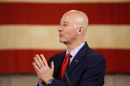 Nebraska Gov. Pete Ricketts speaks at a press briefing in Lincoln, Neb., Wednesday, March 25, 2020. Nebraska approved an $83.6 million emergency relief package Wednesday to help public health officials respond to new coronavirus as the number of cases continued to rise and Gov. Pete Ricketts expanded the list of counties where restaurants and bars will be forced to close their dining areas. (AP Photo/Nati Harnik)