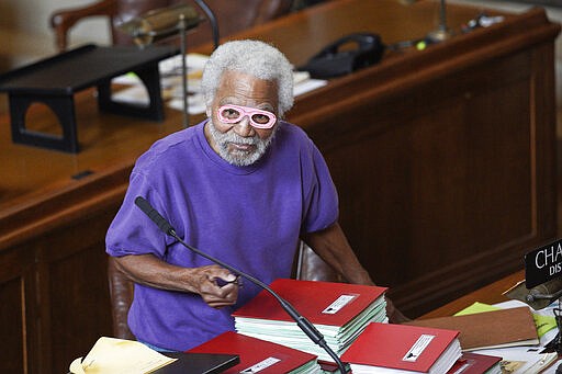 Nebraska Sen. Ernie Chambers of Omaha wears paper glasses as he arrives to the Legislative Chamber in Lincoln, Neb., Wednesday, March 25, 2020. Nebraska approved an $83.6 million emergency relief package Wednesday to help public health officials respond to new coronavirus as the number of cases continued to rise and Gov. Pete Ricketts expanded the list of counties where restaurants and bars will be forced to close their dining areas. (AP Photo/Nati Harnik)