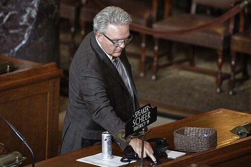 Nebraska Speaker of the Legislature, Jim Scheer of Norfolk, votes yes for funding to combat the coronavirus outbreak, at the Legislative Chamber in Lincoln, Neb., Wednesday, March 25, 2020. Nebraska approved an $83.6 million emergency relief package Wednesday to help public health officials respond to new coronavirus as the number of cases continued to rise and Gov. Pete Ricketts expanded the list of counties where restaurants and bars will be forced to close their dining areas. (AP Photo/Nati Harnik)