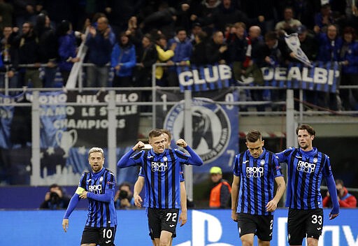 FILE - In this Wednesday, Feb. 19, 2020 file photo, Atalanta's Josip Ilicic, second left, celebrates with teammates after scoring his side's second goal during the Champions League round of 16, first leg, soccer match between Atalanta and Valencia at the San Siro stadium in Milan, Italy. It was the biggest soccer game in Atalanta&#146;s history and a third of Bergamo&#146;s population made the short trip to Milan&#146;s famed San Siro Stadium to witness it. Nearly 2,500 fans of visiting Spanish club Valencia also traveled to the Champions League match. More than a month later, experts are pointing to the Feb. 19 game as one of the biggest reasons why Bergamo has become one of the epicenters of the coronavirus pandemic &#151; a &#147;biological bomb&#148; was the way one respiratory specialist put it &#151; and why 35% of Valencia&#146;s team became infected. The new coronavirus causes mild or moderate symptoms for most people, but for some, especially older adults and people with existing health problems, it can cause more severe illness or death. (AP Photo/Luca Bruno, File)