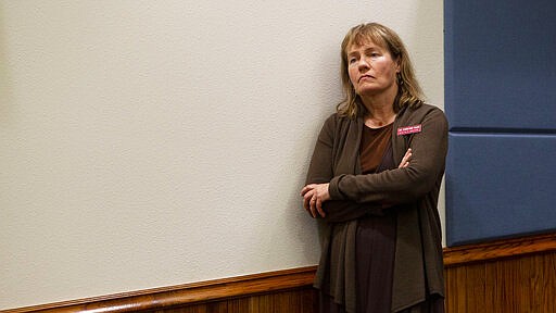 State epidemiologist Dr. Christine Hahn listens during a news conference as Gov. Brad Little issues a statewide stay-at-home order to further prevent spread of coronavirus Wednesday, March 25, 2020 at Gowen Field in Boise, Idaho. (Darin Oswald/Idaho Statesman via AP)