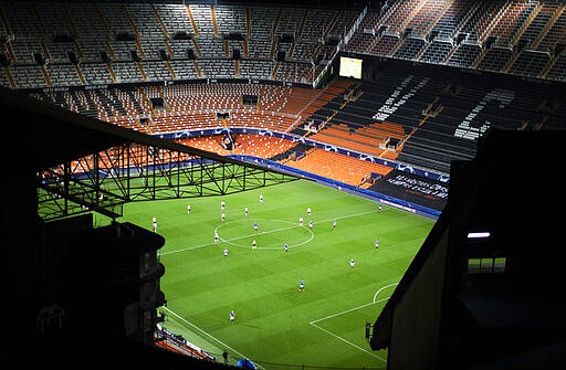 FILE - In this Tuesday March 10, 2020 file photo a general view of the Mestalla stadium during the Champions League round of 16 second leg soccer match between Valencia and Atalanta in Valencia, Spain. It was the biggest soccer game in Atalanta&#146;s history and a third of Bergamo&#146;s population made the short trip to Milan&#146;s famed San Siro Stadium to witness it. Nearly 2,500 fans of visiting Spanish club Valencia also traveled to the Champions League match. More than a month later, experts are pointing to the Feb. 19 game as one of the biggest reasons why Bergamo has become one of the epicenters of the coronavirus pandemic &#151; a &#147;biological bomb&#148; was the way one respiratory specialist put it &#151; and why 35% of Valencia&#146;s team became infected. The new coronavirus causes mild or moderate symptoms for most people, but for some, especially older adults and people with existing health problems, it can cause more severe illness or death. (AP Photo/Emilio Morenatti, File)