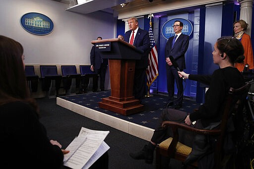 President Donald Trump speaks about the coronavirus in the James Brady Briefing Room, Wednesday, March 25, 2020, in Washington, as Treasury Secretary Steven Mnuchin and Dr. Deborah Birx, White House coronavirus response coordinator, listen. (AP Photo/Alex Brandon)