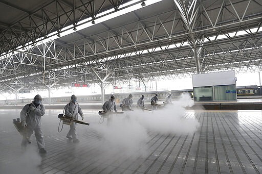 In this March 24, 2020, photo released by Xinhua News Agency, firefighters conduct disinfection on the platform at Yichang East Railway Station in Yichang, in central China's Hubei Province, March 24, 2020. China is re-opening some train stations and bus service as it lifts a lockdown in Hubei province to stem the spread of a new coronavirus. The provincial railway group said that stations would open in all cities except Wuhan on Wednesday. (Photo by Wang Shen/Xinhua)