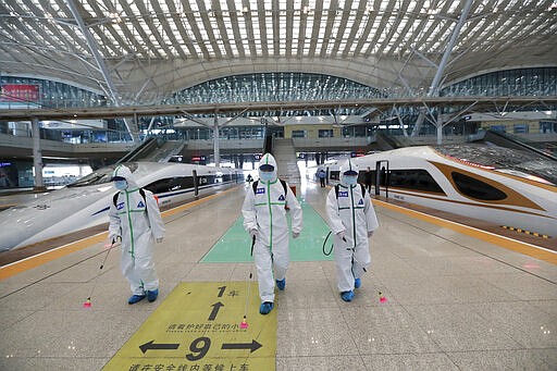 In this photo released by Xinhua News Agency, firefighters conduct disinfection on the platform of Wuhan Railway Station in Wuhan, central China's Hubei Province, March 24, 2020. Chinese authorities said Tuesday they will end a two-month lockdown of most of coronavirus-hit Hubei province at midnight, though the provincial capital will remain closed til April 8, as domestic cases of the virus continue to subside.(Zhao Jun/Xinhua via AP)