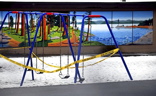 The playground at Sorensen Magnet School of Arts &amp; Humanities in Coeur d'Alene, Idaho is wrapped in police tape to keep children off during the school closure in an attempt to stop the spread of COVID-19 on Wednesday, March 25, 2020. (Kathy Plonka/The Spokesman-Review via AP)