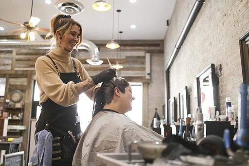 Crystal Hanson colors Charity Stierle's hair at the Urban Nook in Idaho Falls, Idaho, Wednesday, March 25, 2020. Gov. Brad Little issued a stay-home order Wednesday for Idaho residents for the next 21 days. The order requires Idaho's 1.75 million residents to self-isolate at home unless they are healthcare workers, public safety employees or other &#147;essential workers&#148; such as grocery store employees. (John Roark/The Idaho Post-Register via AP)