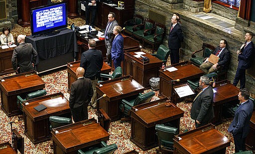 Republican senators observe social distancing as other senators have live-streamed the senate session, Wednesday, March 25, 2020, in Harrisburg, Pa. The state Senate is holding a session to vote on changing the primary election date, among other measures. The Senate session is the first in state history where members can meet online and vote remotely due to the coronavirus pandemic. (Dan Gleiter/The Patriot-News via AP)