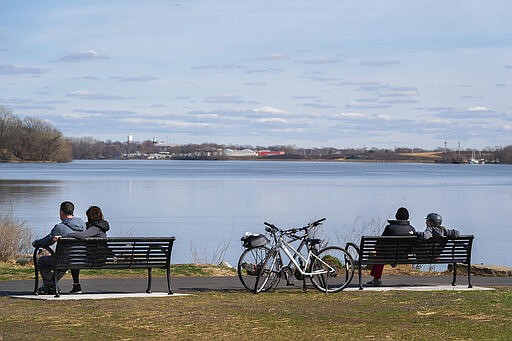 Parkgoers at Penn Treaty Park engage in social distancing from others, in Philadelphia on Tuesday, March 24, 2020. Non-essential businesses are closed and a stay-at-home order has been issued by the city, with exceptions to allow people to purchase essential goods and food or seek medical attention, to try to reduce the spread of the coronavirus in Philadelphia. Outdoor activities such as walking, running and cycling are permitted under the order. (Jessica Griffin/The Philadelphia Inquirer via AP)