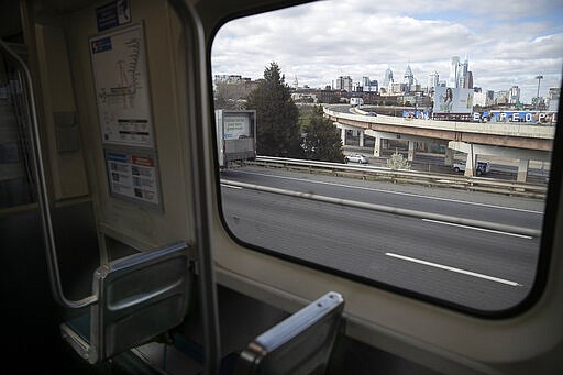 The Philadelphia skyline is seen from a window of the SEPTA Market-Frankford Line heading westbound Tuesday, March 24, 2020. Non-essential businesses are closed and a stay-at-home order has been issued by the city, with the exception of those working for life-sustaining businesses, due to the spread of the coronavirus. (Heather Khalifa/The Philadelphia Inquirer via AP)