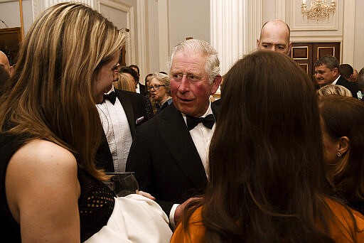 FILE - In this March 12, 2020 file photo, Britain's Prince Charles, centre, meets guests at a dinner at Mansion House in London. Prince Charles, the heir to the British throne, has tested positive for the new coronavirus. The prince&#146;s Clarence House office reported on Wednesday, March 25, 2020 that the 71-year-old is showing mild symptoms of COVID-19 and is self-isolating at a royal estate in Scotland. It says his wife Camilla has tested negative. (Eamonn McCormack/PA via AP, File)