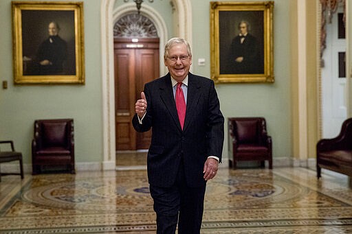 Senate Majority Leader Mitch McConnell of Ky. gives a thumbs up as he arrives on Capitol Hill, Wednesday, March 25, 2020, in Washington. (AP Photo/Andrew Harnik)