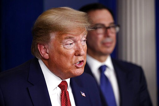 President Donald Trump speaks about the coronavirus in the James Brady Briefing Room, Wednesday, March 25, 2020, in Washington, as Treasury Secretary Steven Mnuchin listens. (AP Photo/Alex Brandon)