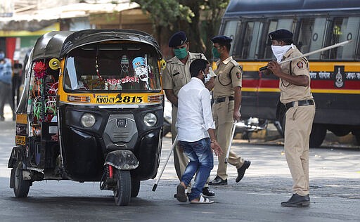 Policemen beat a curfew violator in Mumbai, India, Wednesday, March 25, 2020. The world's largest democracy went under the world's biggest lockdown Wednesday, with India's 1.3 billion people ordered to stay home in a bid to stop the coronavirus pandemic from spreading and overwhelming its fragile health care system as it has done elsewhere. For most people, the new coronavirus causes mild or moderate symptoms, such as fever and cough that clear up in two to three weeks. For some, especially older adults and people with existing health problems, it can cause more severe illness, including pneumonia and death. (AP Photo/Rafiq Maqbool)