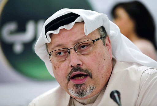 FILE - In this Dec. 15, 2014 file photo, Saudi journalist Jamal Khashoggi speaks during a press conference in Manama, Bahrain. Three leading international NGOs say they're boycotting meetings Saudi Arabia is holding with civil society groups ahead of hosting this year's Group of 20 summit. Transparency International, Amnesty International and CIVICUS said Monday, Jan. 13, 2020 that participating would lend legitimacy to a kingdom &#147;trying to whitewash its dire human rights record.&#148; (AP Photo/Hasan Jamali, File)