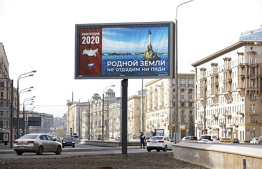 A billboard with a picture of Sevastopol that reads: &quot;Not an inch of our Dear Land to be Surrendered&quot; is displayed in Moscow, Russia, Wednesday, March 25, 2020. Russian President Vladimir Putin has postponed a nationwide vote on proposed constitutional amendments that include a change potentially allowing him to stay in office until 2036. Putin cited the coronavirus in announcing the postponement of the vote that was originally scheduled for April 22. (AP Photo/Alexander Zemlianichenko)