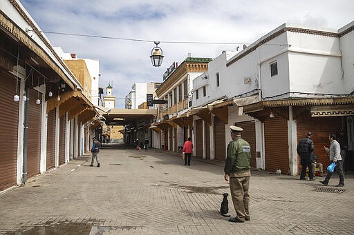 A policeman instructs people to empty the streets and stay indoors after a health state of emergency was declared and members of the public ordered to a home confinement, in Rabat, Morocco, Sunday, March 22, 2020. For some people the COVID-19 coronavirus causes mild or moderate symptoms, but for some it can cause severe illness including pneumonia. (AP Photo/Mosa'ab Elshamy)