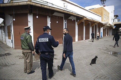 Members of the security forces instruct people to empty the streets and stay indoors, after a health state of emergency was declared and members of the public ordered to a home confinement, in Rabat, Morocco, Sunday, March 22, 2020. For some people the COVID-19 coronavirus causes mild or moderate symptoms, but for some it can cause severe illness including pneumonia. (AP Photo/Mosa'ab Elshamy)