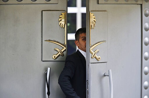 FILE - In this Tuesday, Oct. 9, 2018 file photo, a security guard walks in the Saudi Arabia consulate in Istanbul, Turkey. On Wednesday, March 25, 2020.  Turkish prosecutors have formally charged two former aides of Saudi Crown Prince Mohammed bin Salman and 18 other Saudi nationals over the 2018 killing of Khashoggi, although all suspects have left Turkey and Saudi Arabia has rejected Turkish calls for their return to face trial. (AP Photo/Lefteris Pitarakis, File)