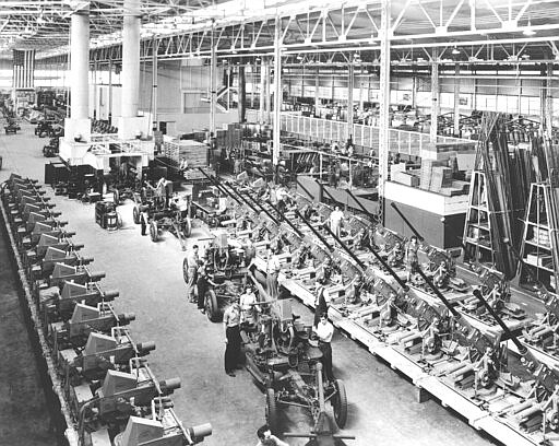 FILE - In this Oct. 22, 1942, file photo, Bofors 4-millimeter cannons used by the Army and Navy are shown lined up at the Firestone Tire &amp; Rubber Co. in Akron, Ohio. In the background, gun mounts and carriages are being assembled. Not since World War II when factories converted from making automobiles to making tanks, Jeeps and torpedos has the entire nation been asked to truly sacrifice for a greater good. (AP Photo, File)