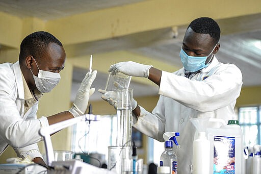 Laboratory technicians from Mount Kenya University produce hand sanitizer gel from locally-produced alcohol in response to the scarcity of such products as a result of high demand due to the new coronavirus, for use by the tens of thousands of university students and staff in its campuses across the country, in Thika, north of the capital Nairobi, in Kenya Wednesday, March 25, 2020. The new coronavirus causes mild or moderate symptoms for most people, but for some, especially older adults and people with existing health problems, it can cause more severe illness or death. (AP Photo/John Muchucha)