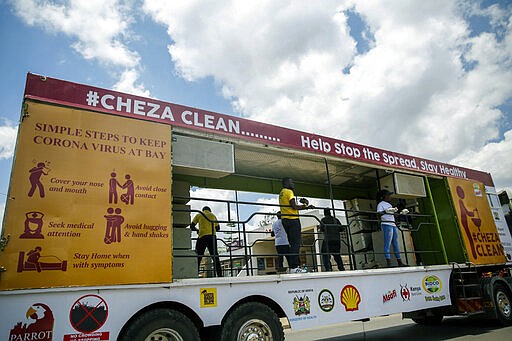 In this photo taken Tuesday, March 24, 2020, a truck drives around to create awareness of hand washing being one of the easiest and most effective ways to limit the spread of the new coronavirus, in the Mathare slum, or informal settlement, of Nairobi, Kenya. Many slum residents say staying at home or social-distancing is impossible for those who live hand to mouth, receiving daily wages for informal work with no food or economic assistance from the government, as is maintaining sanitation where a pit latrine can be shared by over 50 people. The new coronavirus causes mild or moderate symptoms for most people, but for some, especially older adults and people with existing health problems, it can cause more severe illness or death. (AP Photo/Brian Inganga)