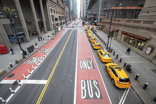 Yellow cabs line an empty 42nd St. waiting for fares outside Grand Central Terminal, Wednesday, March 25, 2020, in New York. Hospitalizations from COVID-19 were rising faster than expected in New York as residents and leaders prepared for a peak in cases that is expected to still be weeks away. Temporary hospitals, and even a morgue in Manhattan, are being setup. (AP Photo/Mary Altaffer)