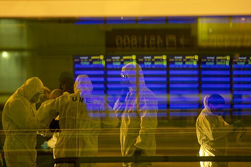 FILE - In this Thursday, March 19, 2020, file photo, Spanish UME (Emergency Army Unit) soldiers disinfect a terminal to prevent the spread of the new coronavirus at a Barcelona airport in Spain. World War II references are now heard daily &#151; not because another momentous 75th anniversary, Victory in Europe Day approaches in May but because of the coronavirus. (AP Photo/Emilio Morenatti, File)